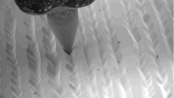 <p>A stylus reading a stereo vinyl shown via an electron microscope</p>